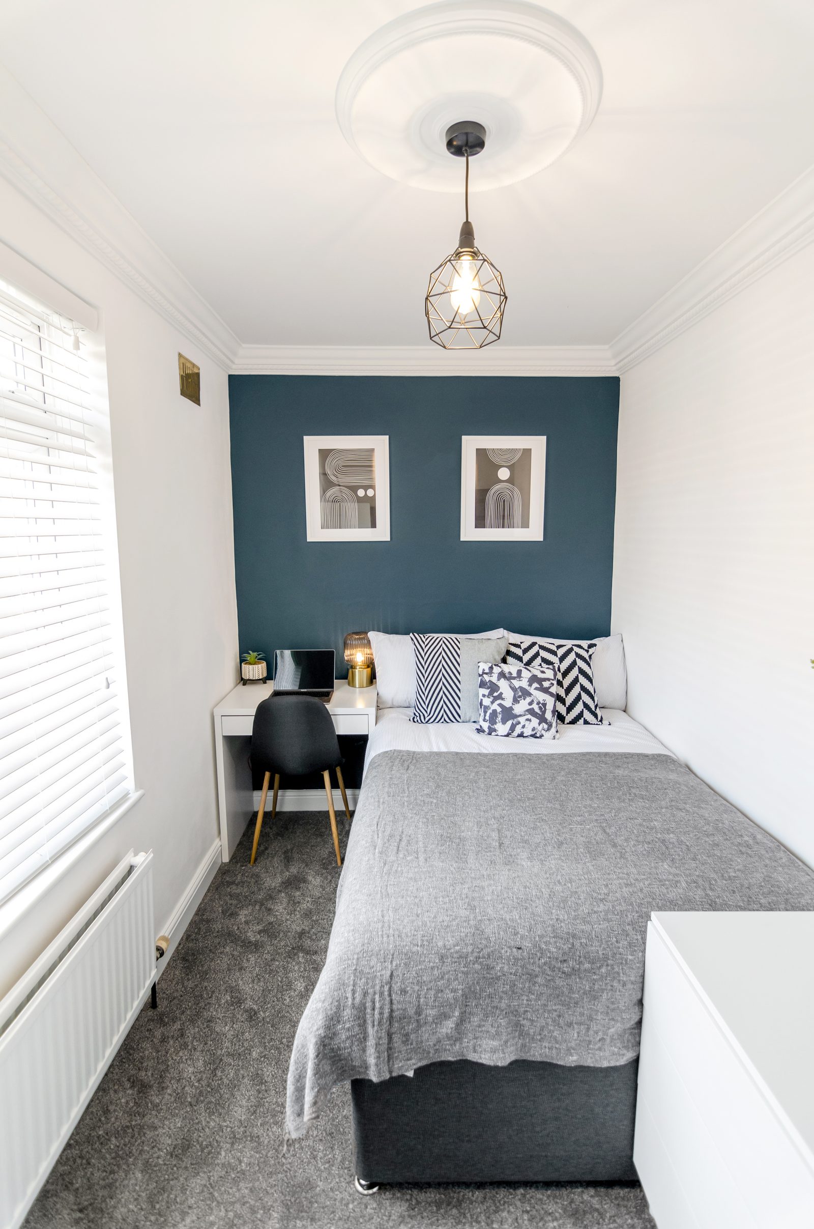 Bedroom with teal feature wall at Horning Close