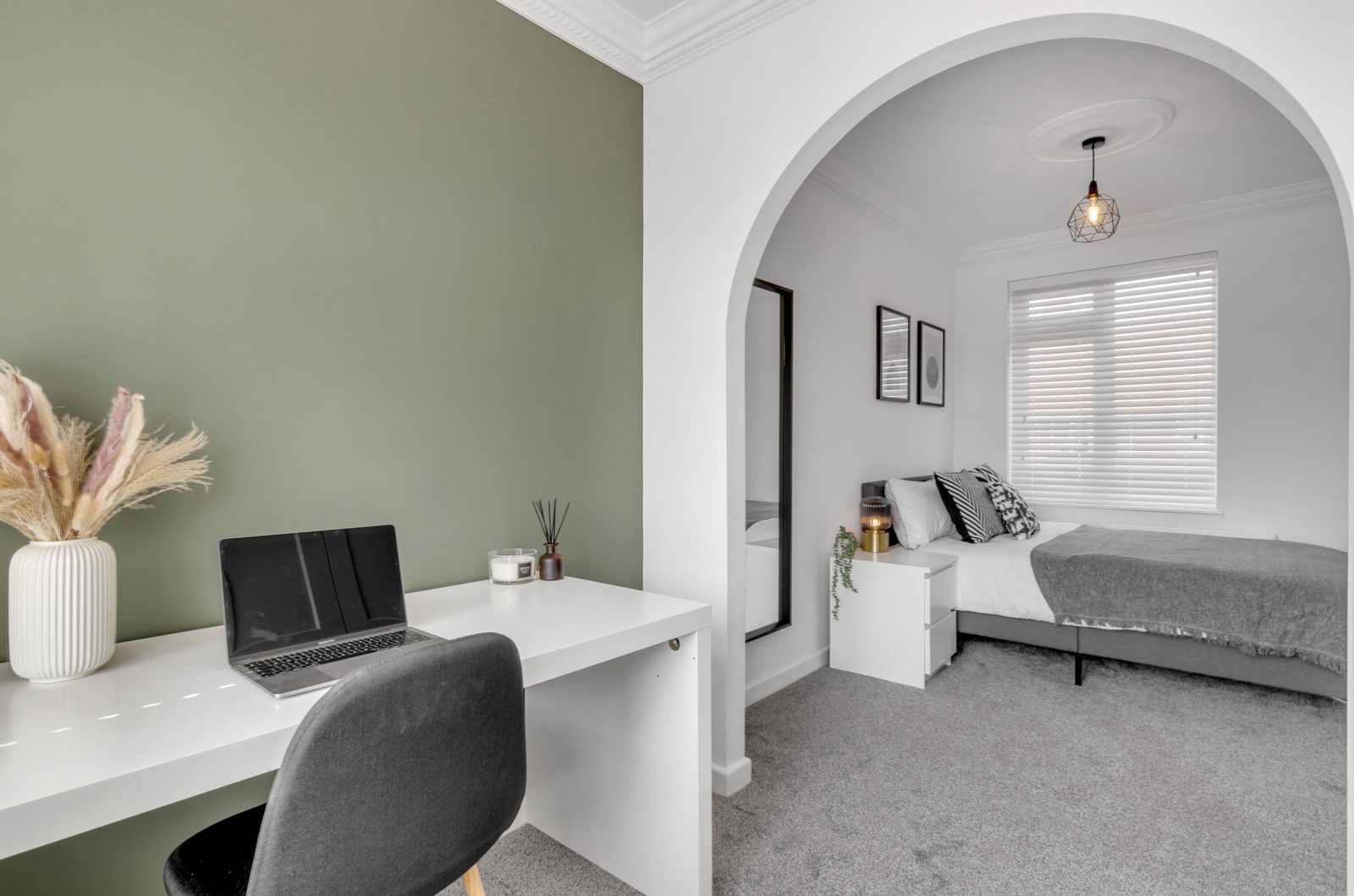 Bedroom at Horning Close, with desk and en-suite through the archway